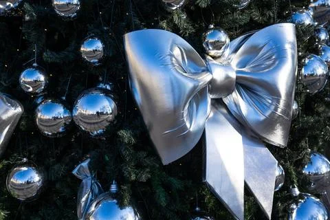 Christmas decorations on the branches of the tree. A bow on the Christmas tre Stock Photos