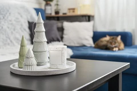 Christmas decorations with candle on coffee table Stock Photos