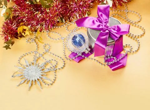 Christmas decorations composition with present on yellow background Foto stock