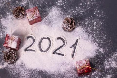 Christmas decorations, decor elements in the snow. red gifts and cones. Finger Stock Photos