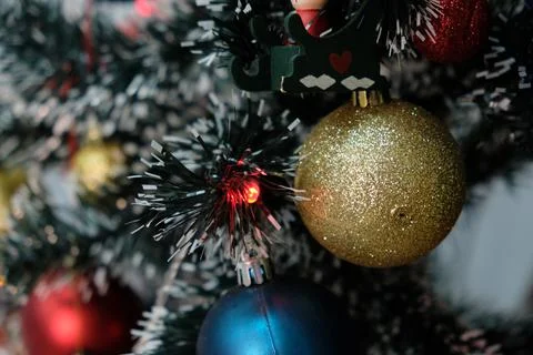 Christmas decorations on evergreen tree branches with shining garlands Stock Photos