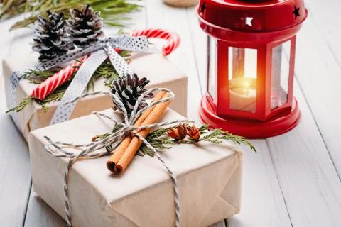 Christmas decorations with gift boxes, pine cones and lantern with candle on  Stock Photos