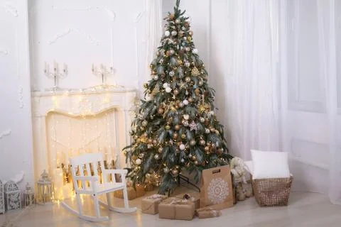 Christmas decorations gift boxes in wrapping paper near Christmas tree Stock Photos