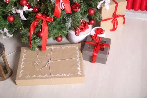 Christmas decorations gift boxes in wrapping paper near Christmas tree Stock Photos