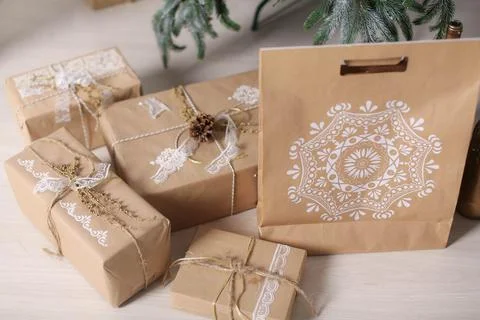 Christmas decorations gift boxes in wrapping paper near Christmas tree Stock Photos