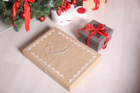 Christmas decorations gift boxes in wrapping paper near Christmas tree Stock Photos