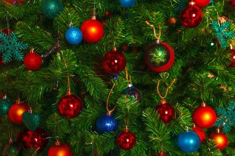 Christmas decorations hang on the tree with multi-colored glass balls Stock Photos