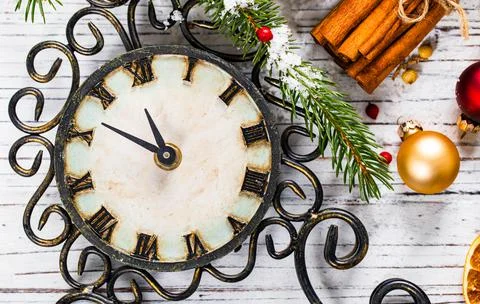 Christmas decorations next to a clock counting down to New Year Stock Photos