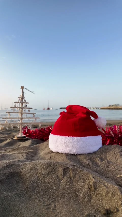 Christmas decorations with a santa hat on a warm tropical beach Stock Footage 346249291