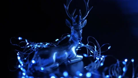 Christmas decorations. Silver deer and shining blue garland Stock-Footage 249732115
