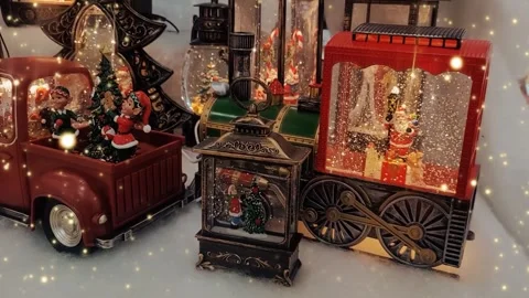 Christmas decorations with sparkles on the table. Red car with elves and a Chris Stock Footage 294735544