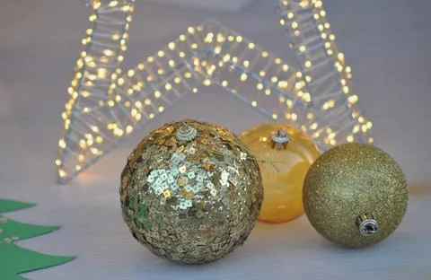Christmas decorative objects on a background with lit lights, balls and stars Stock Photos
