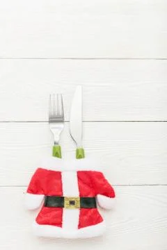 Christmas dinner concept with fork, knife on white wooden texture. Flat lay Stock Photos