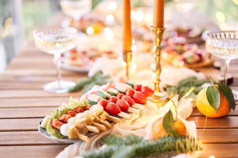 Christmas dinner feast. A small table is served with snacks, bruschettas, and Stock Photos