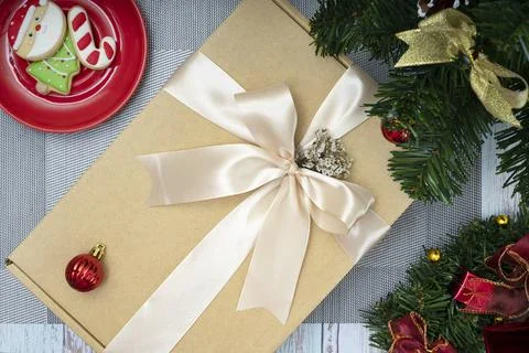 Christmas dinner table decorations with a gift box and sugar coated biscuits. Stock Photos