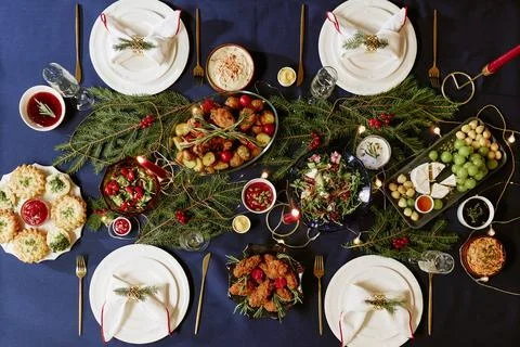 Christmas Dinner Table Setting Featuring Festive Food and Holiday Decor Stock Photos