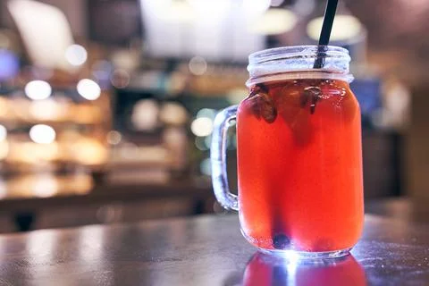 Christmas drink mulled wine with a straw on the background of the cafe interior Stock-Fotos