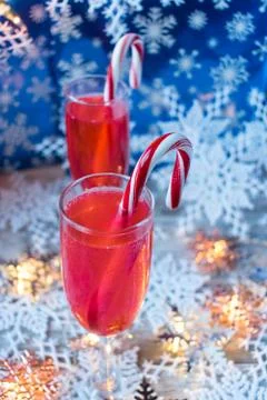 Christmas drinks with candy cane surrounded by snowflakes in festive setting Stock Photos