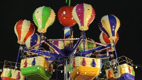 Christmas Fair. Multicolored carousel is spinning in amusement park, Holiday. Stock Footage 83668024