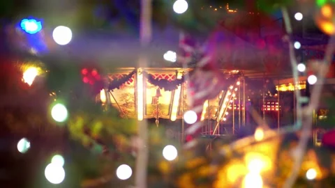 Christmas fair view of the rides through christmas tree with luminous garlands Stock Footage 227122196