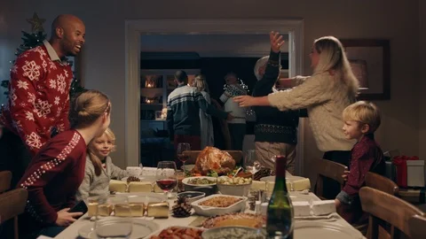 Christmas family hugging arriving for dinner party celebrating festive holiday Stock Footage