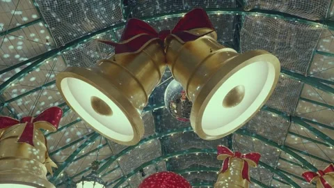 Christmas Festive Decorations Featuring Large Hanging Gold Bells with Red Bows Stock Footage 331105419