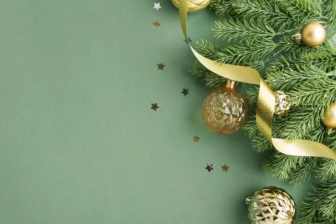 Christmas festive decorations with pine branches baubles and ribbon on gree.. Stock Photos