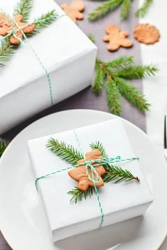 Christmas festive table setting, plate with gift decorated with spruce spri.. Stock Photos