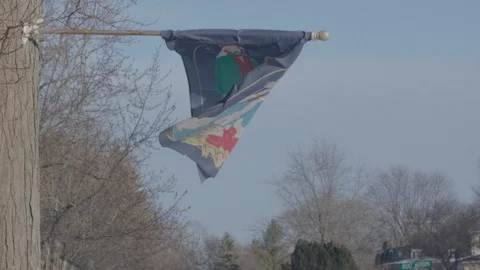 Christmas flag waving in the wind in front of a blue sky. Slow motion (120fps at Stock Footage 86567348
