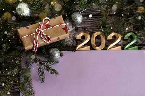 Christmas flat lay composition of craft gifts and golden numbers 2022 on dark Stock Photos