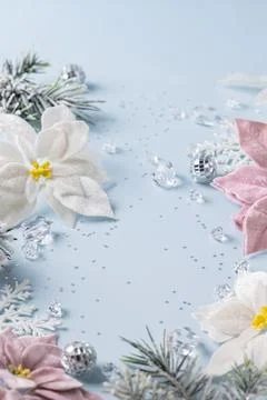 Christmas flat lay frame with white and pink poinsettias silver ornaments a.. Fotos de archivo