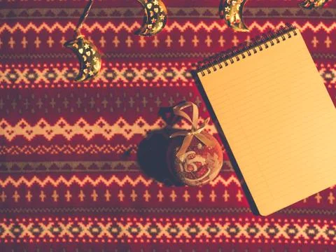 Christmas flat lay. Note and toys on red pattern background Stock Photos