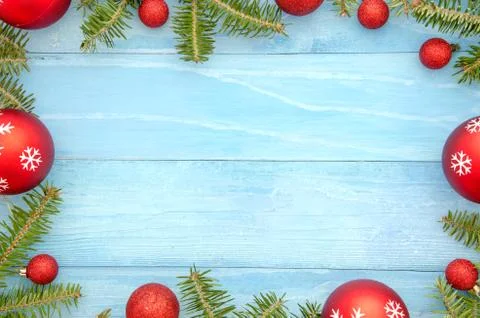 Christmas frame background with red balls decor and fir tree. on light blue Stock Photos