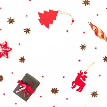 Christmas frame composition. Present gift box, red toys and confetti on white Foto stock