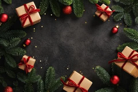Christmas frame with gift boxes with red ribbons and pine branches on dark ba 스톡 사진
