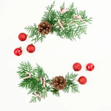 Christmas frame made of pine branches and red balls decoration with candy can Stock Photos