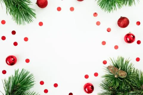 Christmas frame made of pine branches and red balls decoration with confetti  Stock Photos