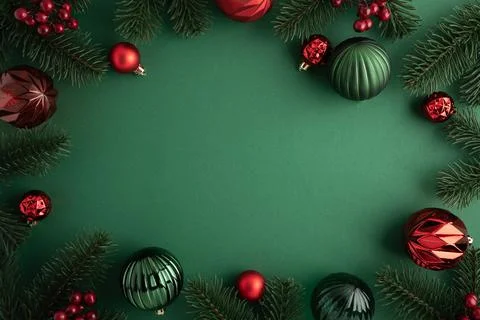 Christmas frame with pine branches and ornaments on green background Stock Photos