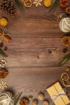 Christmas frame with pine cones, cinnamon and cookies on wooden background... Stock Photos