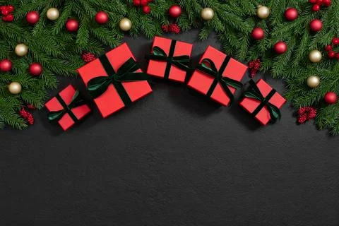 Christmas frame with red gift boxes and fir branches with festive decor Stock Photos