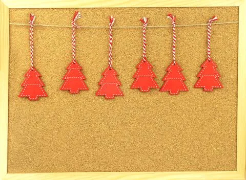 Christmas frame. Red trees on blank notice board made of cork as backdrop. Wo Stock Photos
