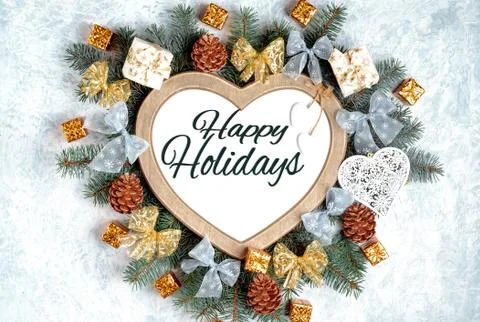 Christmas frame in the shape of a heart is surrounded by branches of a New Ye Stock Photos