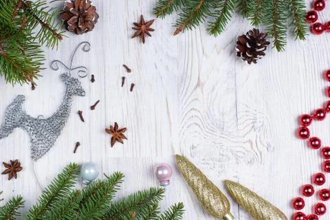 Christmas frame for text or image with a deer, fir branches and beads on a li Stock Photos