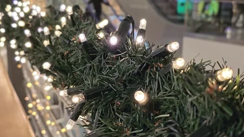 Christmas garland with LED string lights and green artificial pine branches Stock Footage 297012454