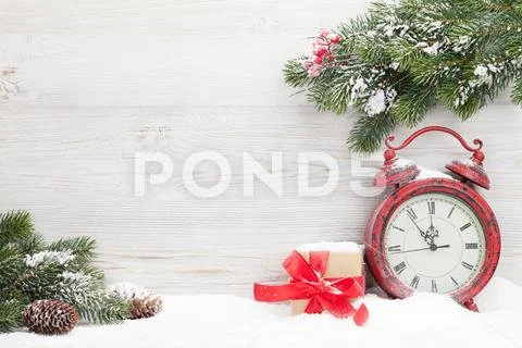 Christmas gift box, alarm clock and fir tree Stock Photos