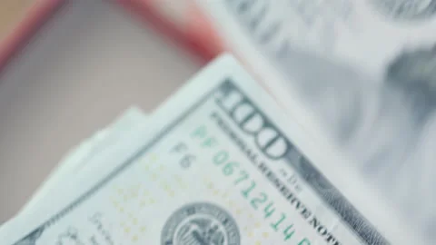 Christmas gift box in background and hand counting money American dollars in a Stock Footage 158734556