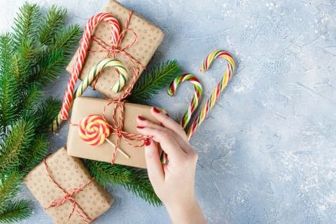 Christmas gift box, candy cane and fir tree branch Stock Photos