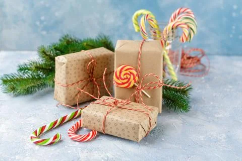 Christmas gift box, candy cane and fir tree branch Stock Photos