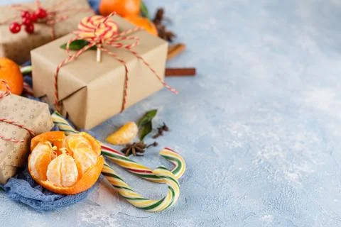 Christmas gift box, candy cane, tangerines Stock Photos