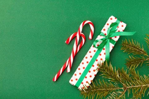 Christmas gift box with candy canes and pine branch Stock Photos